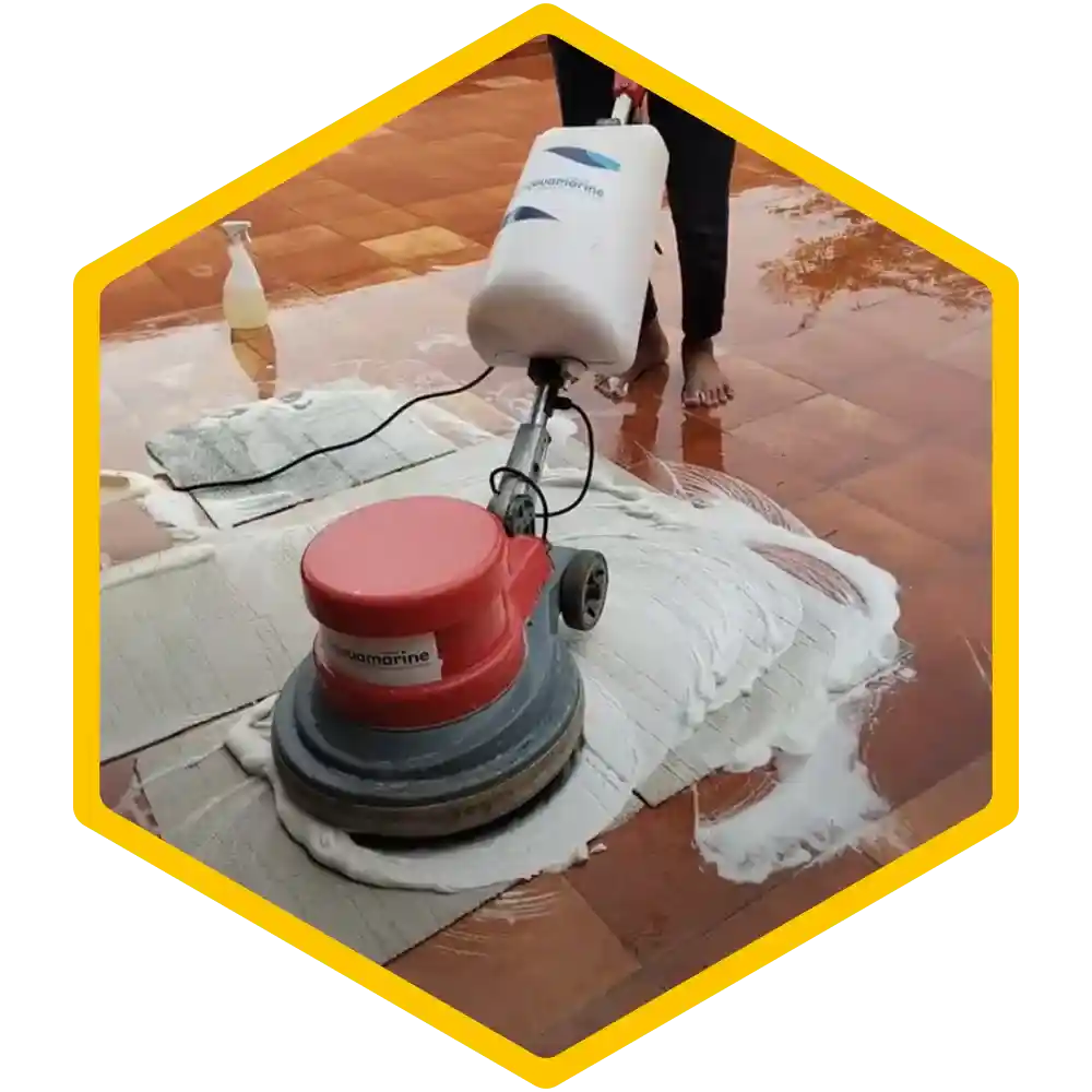 Worker using a steam cleaner to deep clean a carpet.